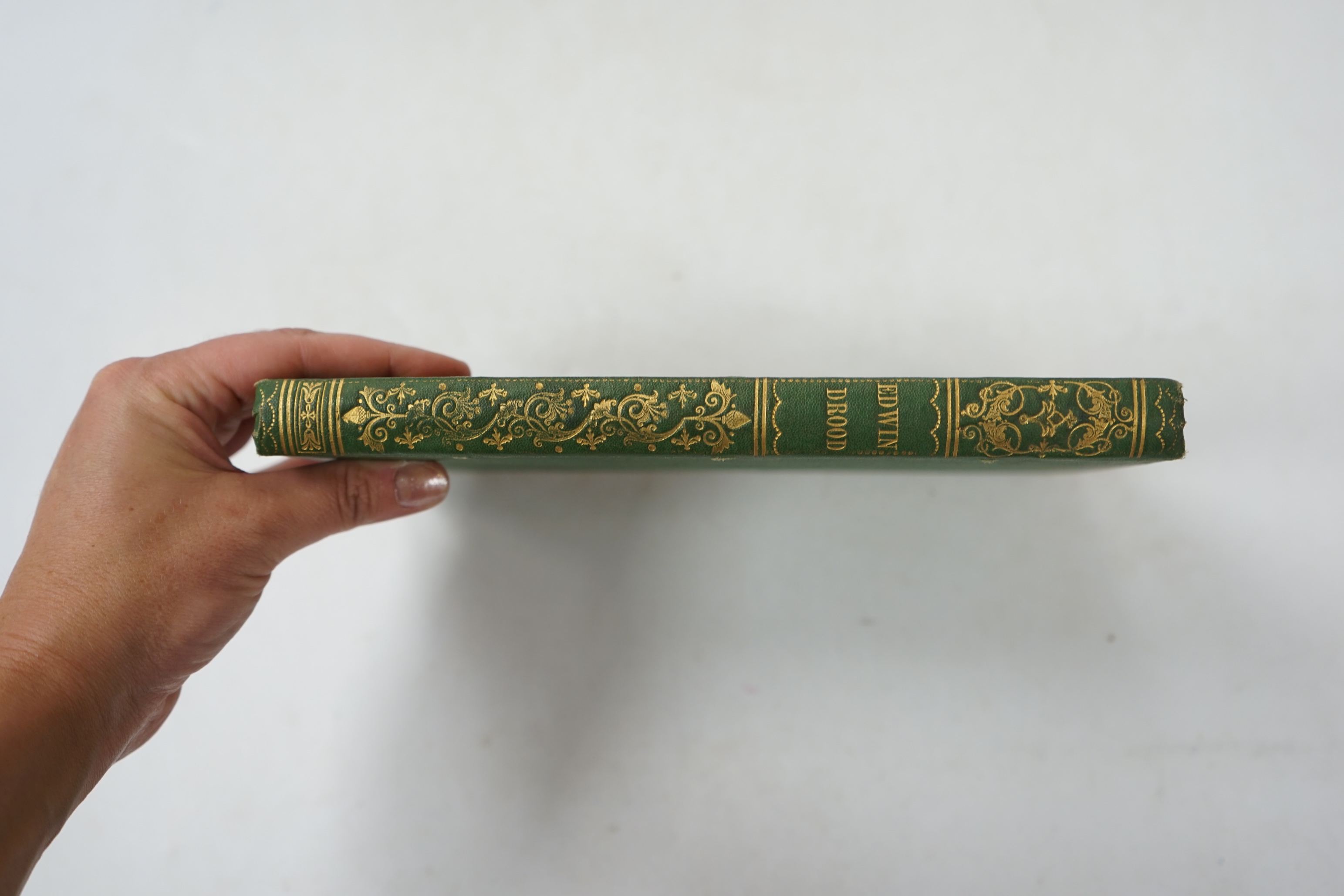 Dickens, Charles - The Mystery of Edwin Drood. 1st edition. engraved pictorial and printed titles, portrait frontis. and 12 plates (by S.L. Fildes), advert. leaf at end; near contemp. gilt decorated green cloth. 1870
